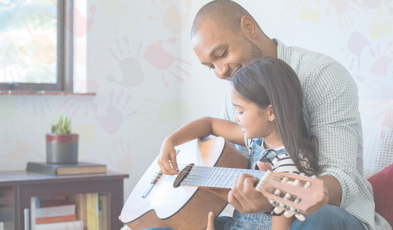 Father and Daughter playing guitar